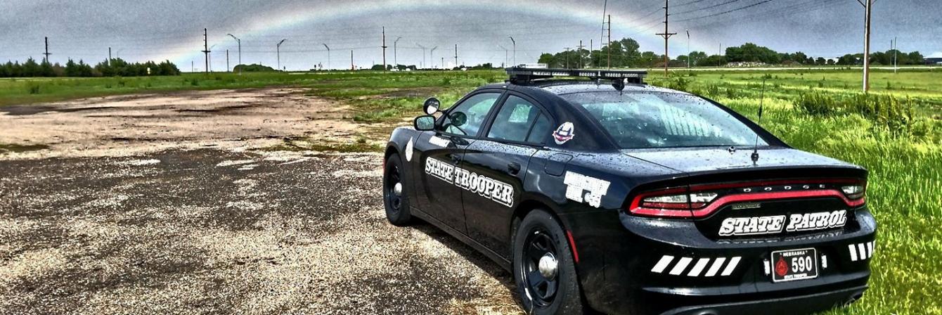 patrol vehicle with rainbow in distance