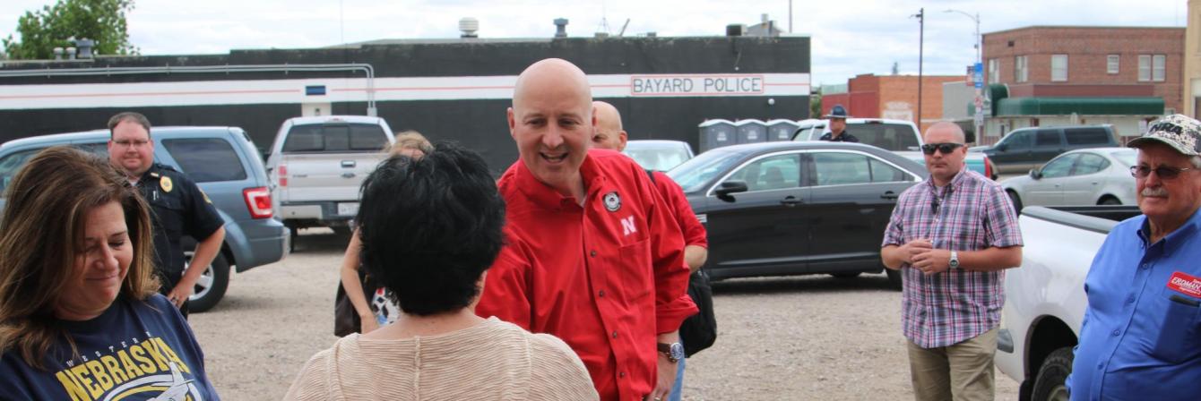 Governor Pete Ricketts shaking hands with group of people