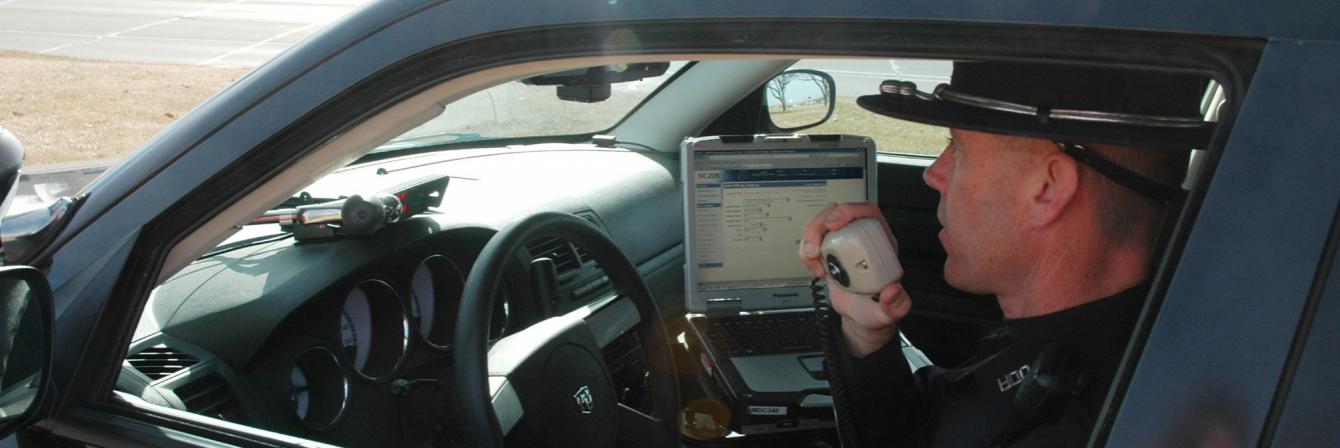 officer in patrol car talking on radio