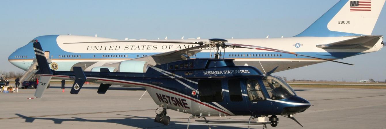 nebraska state patrol helicopter next to united states government airplane