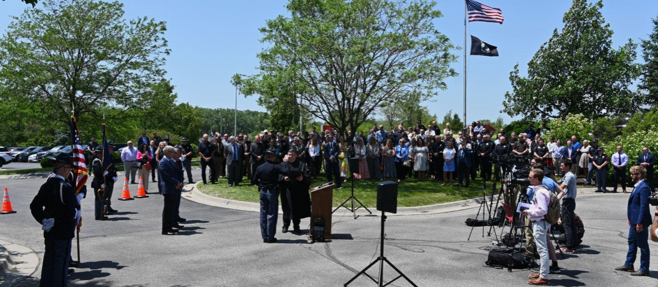 Colonel Bryan Waugh is sworn-in as family, colleagues, and friends look on.