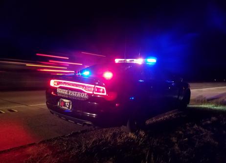state patrol vehicle with lights on at night