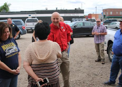 Governor Pete Ricketts shaking hands with group of people