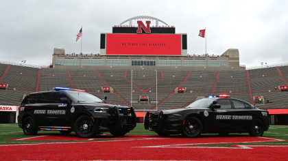 Two Nebraska State Patrol Cruisers on the field at Memorial Stadium