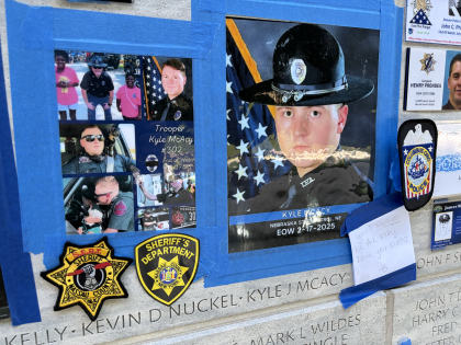 Trooper Kyle Mcacy's photo taped to the National Law Enforcement Memorial just about his name engraved in the memorial.