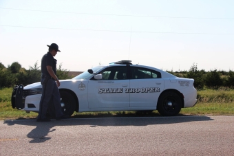 officer standing next to white patrol vehicle