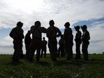 personnel in body armor standing in circle