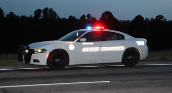white patrol vehicle with lights on at night